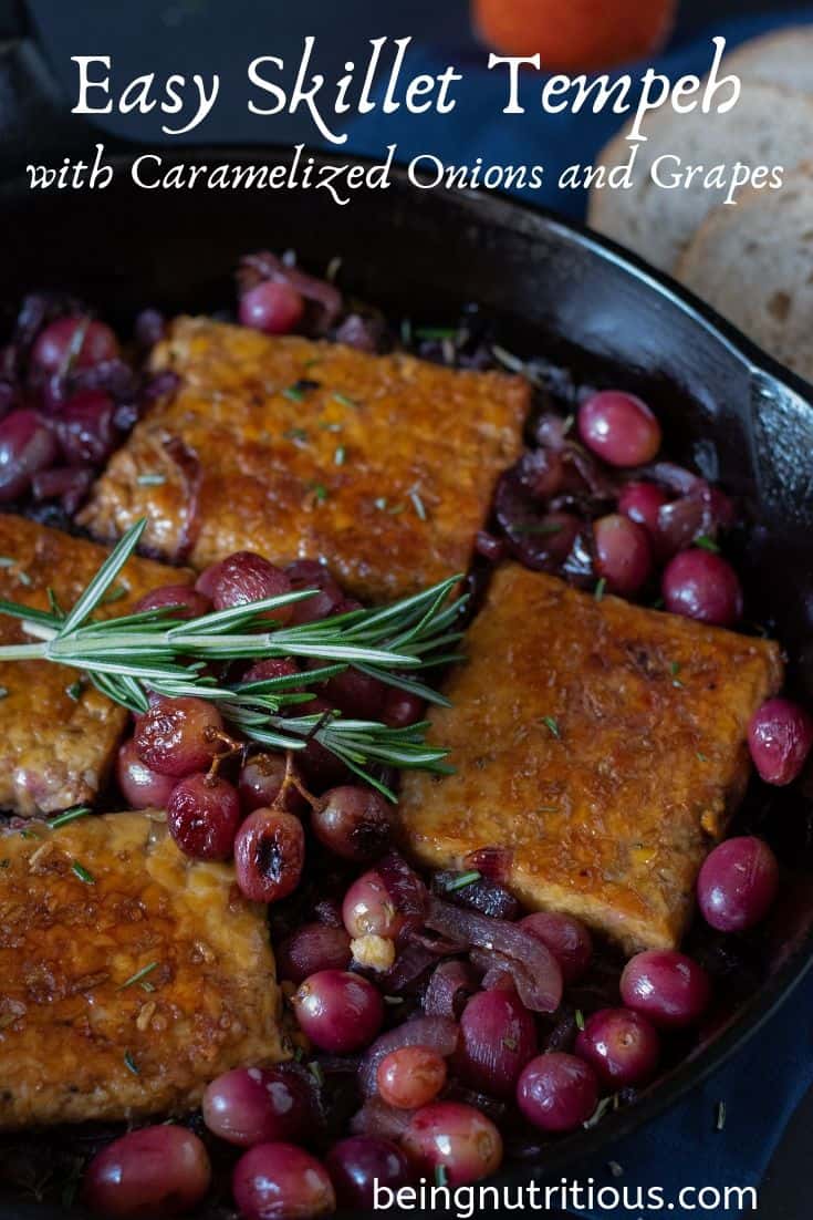 Sauteed tempeh in a skilled with caramelized onions and grapes. Text overlay: Easy Skillet Tempeh with caramelized onions and grapes.