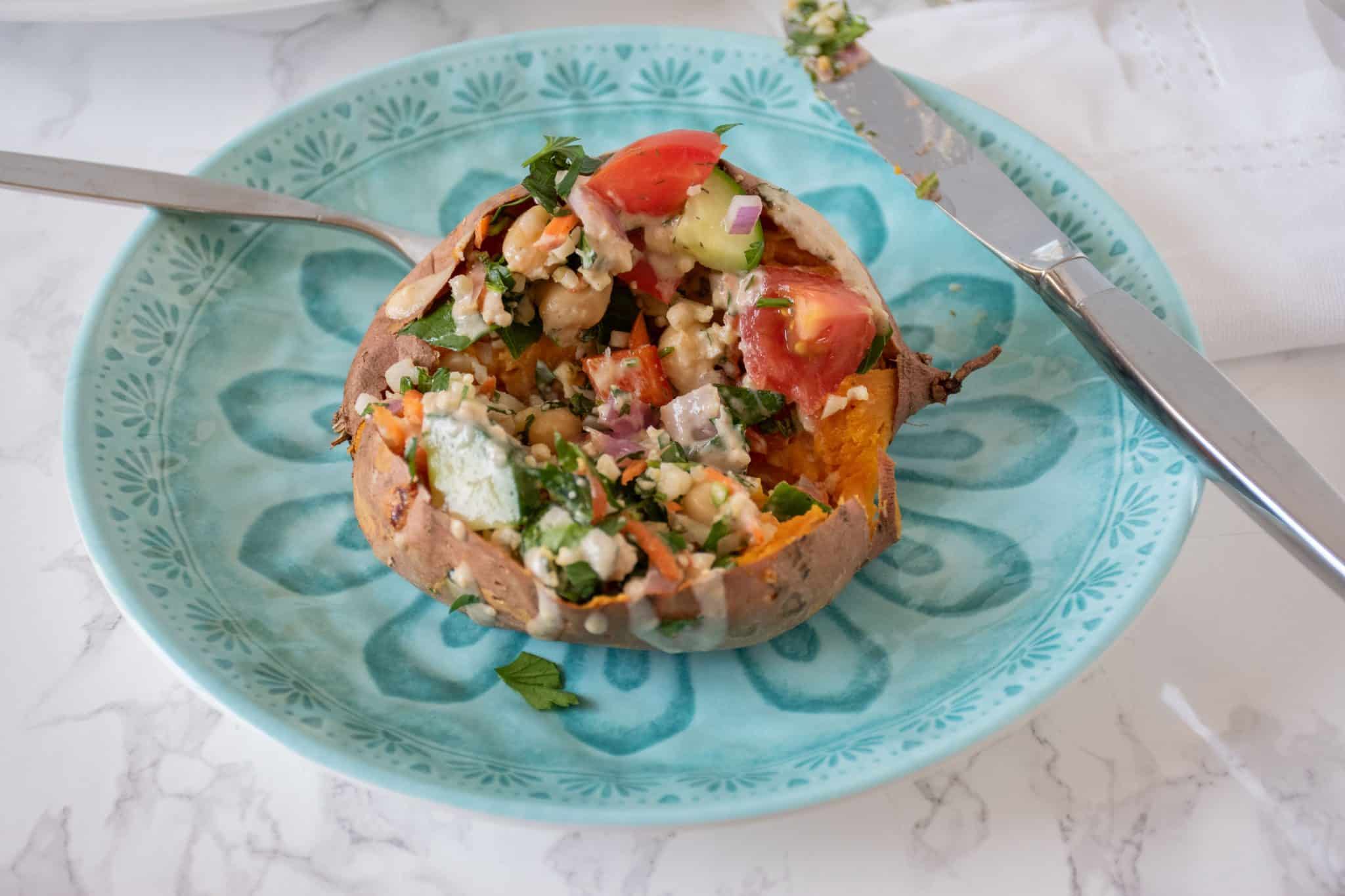 Stuffed sweet potato cut open to eat