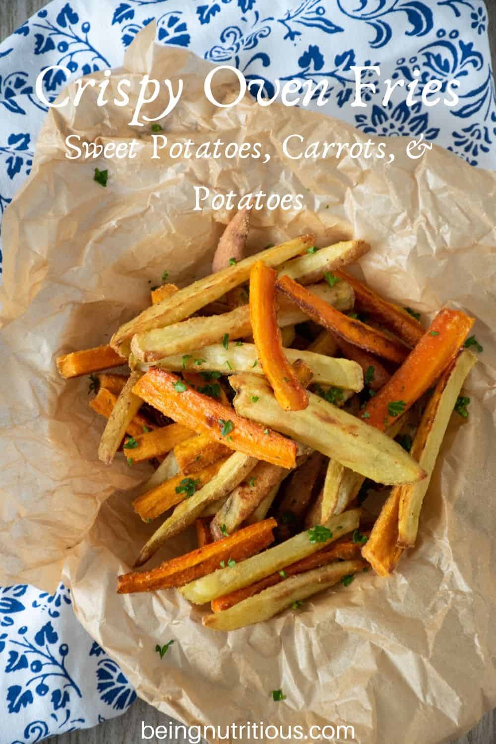 Overhead view of a basket of root vegetable fries. Text overlay: Crispy Oven Fries; sweet potatoes, carrots, and potatoes.