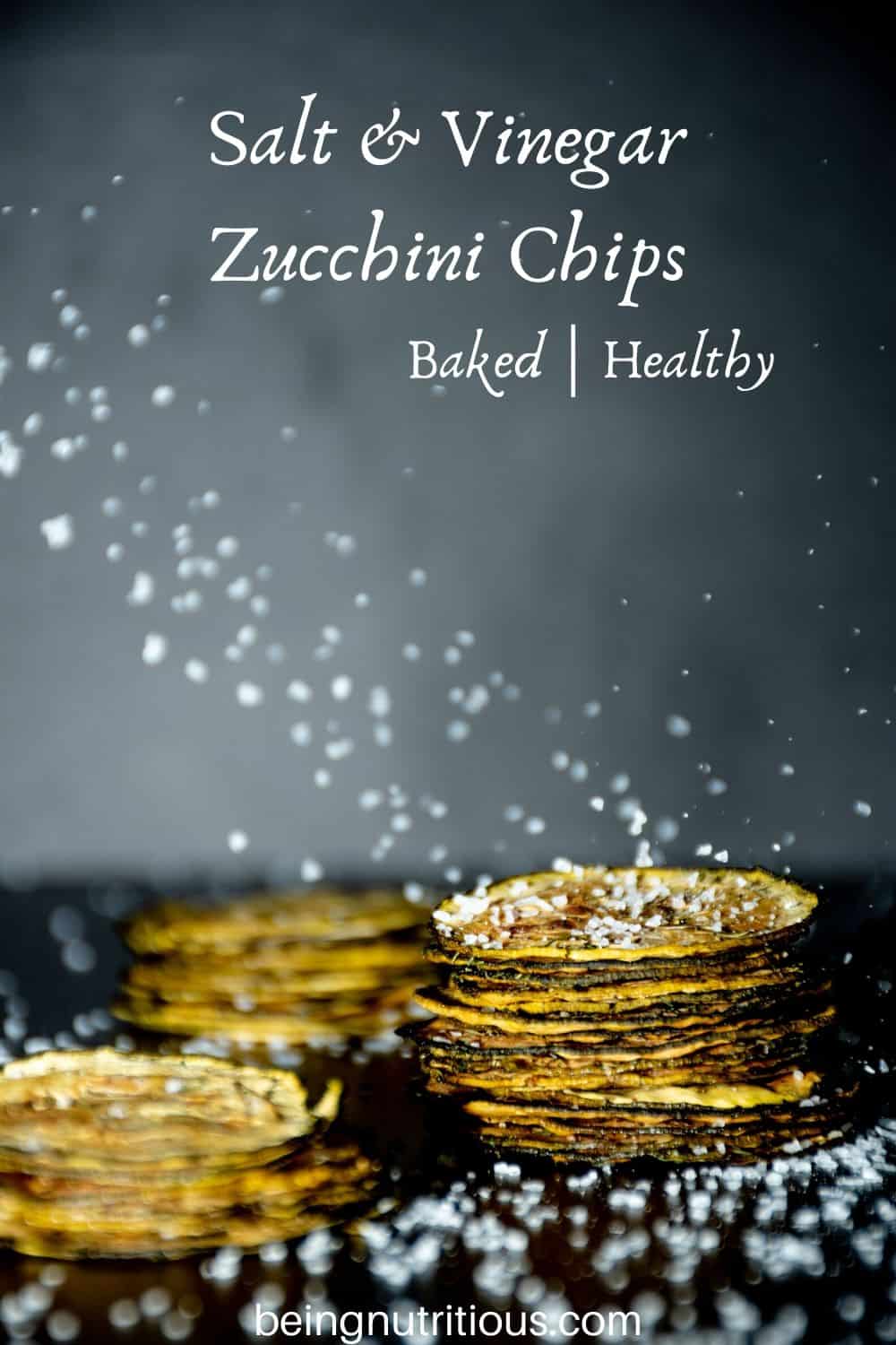 Image of 3 stacks of zucchini chips, with salt crystals falling all around.