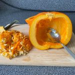 Pumpkin cut in half with seeds removed.