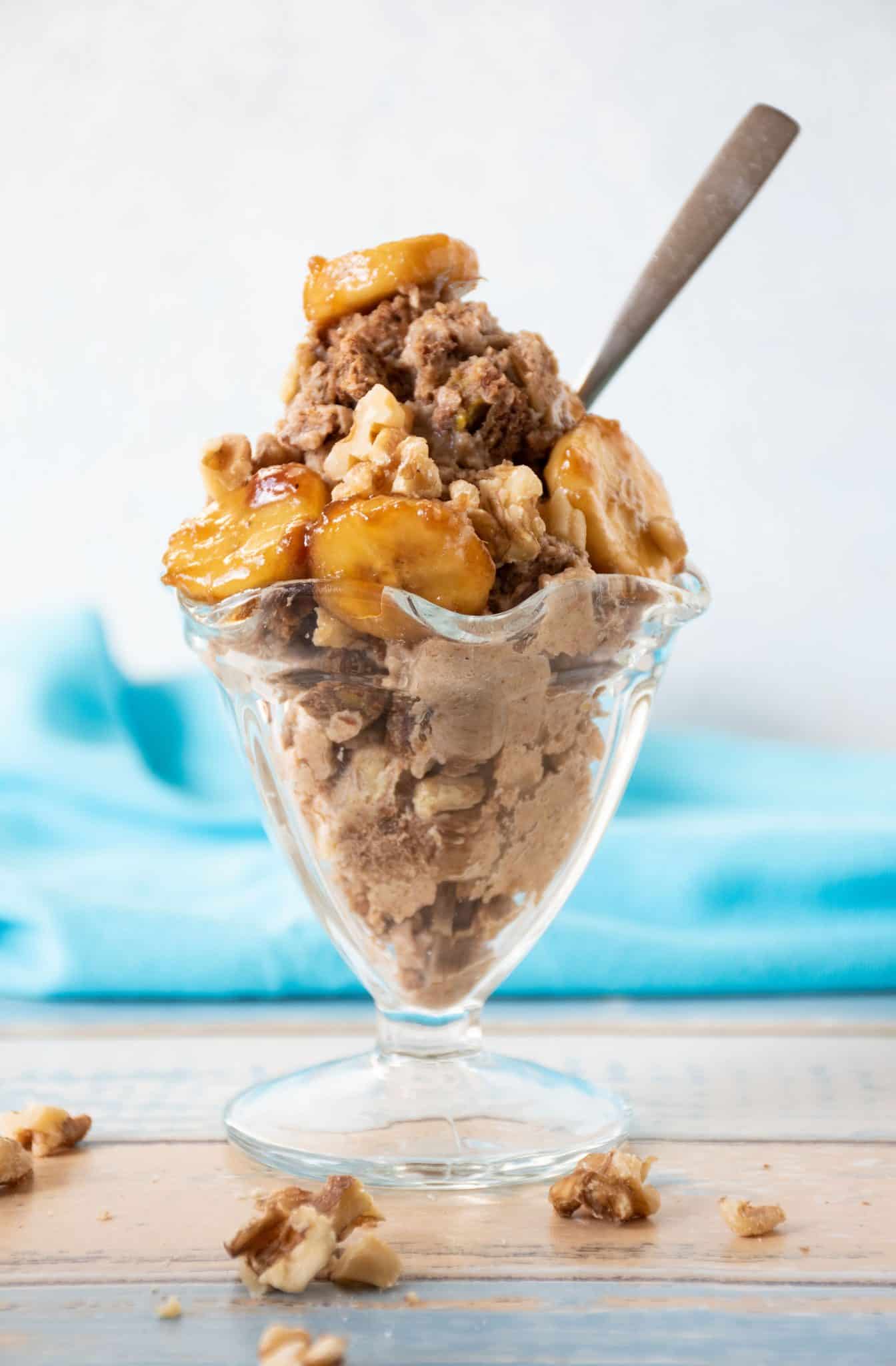 Glass sundae dish with ice cream and a spoon.