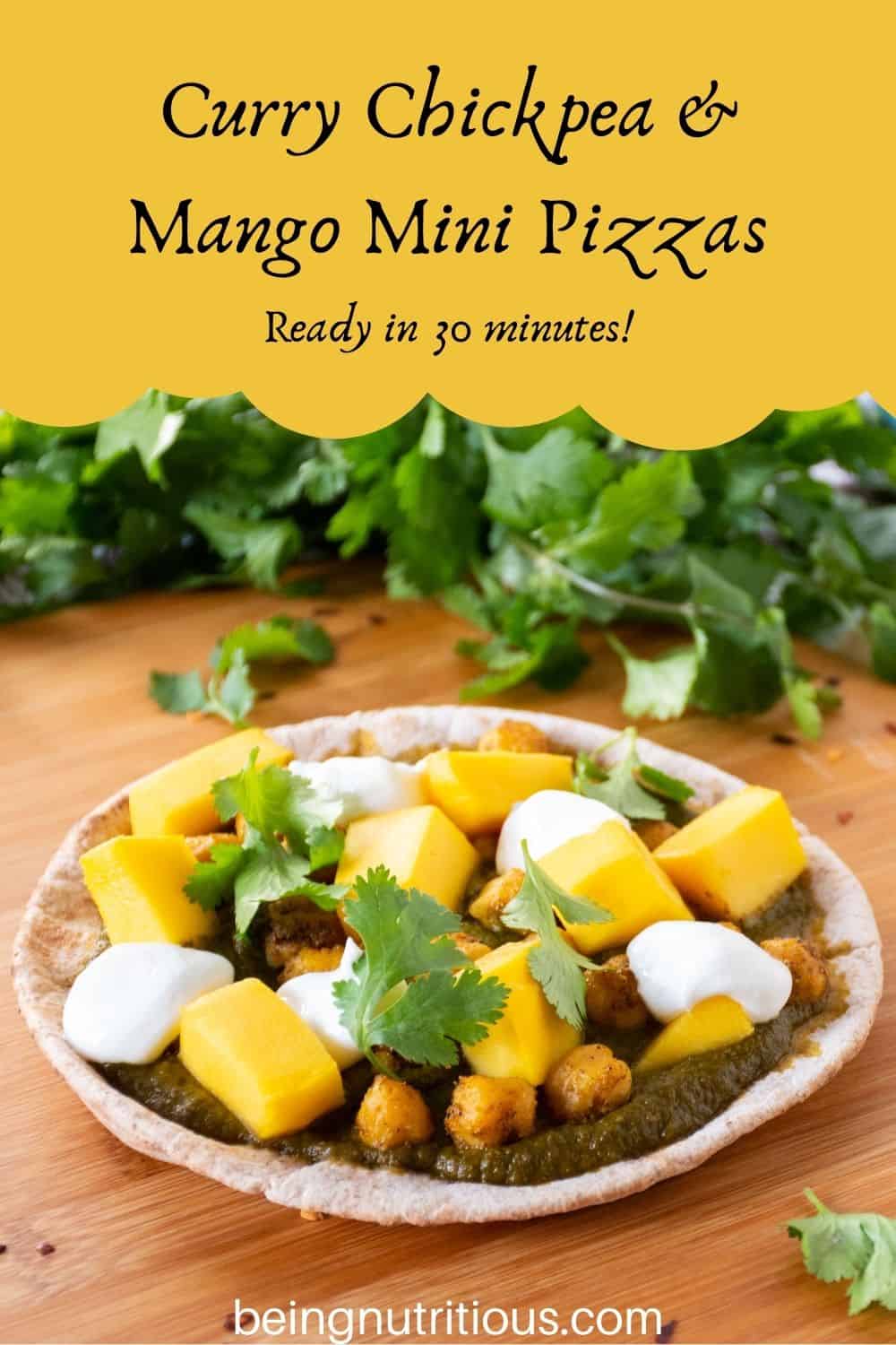 pizza with spinach sauce, chickpeas, and mangoes on a mini pita. Text overlay: Curry Chickpea & mango mini pizzas; ready in 30 minutes!