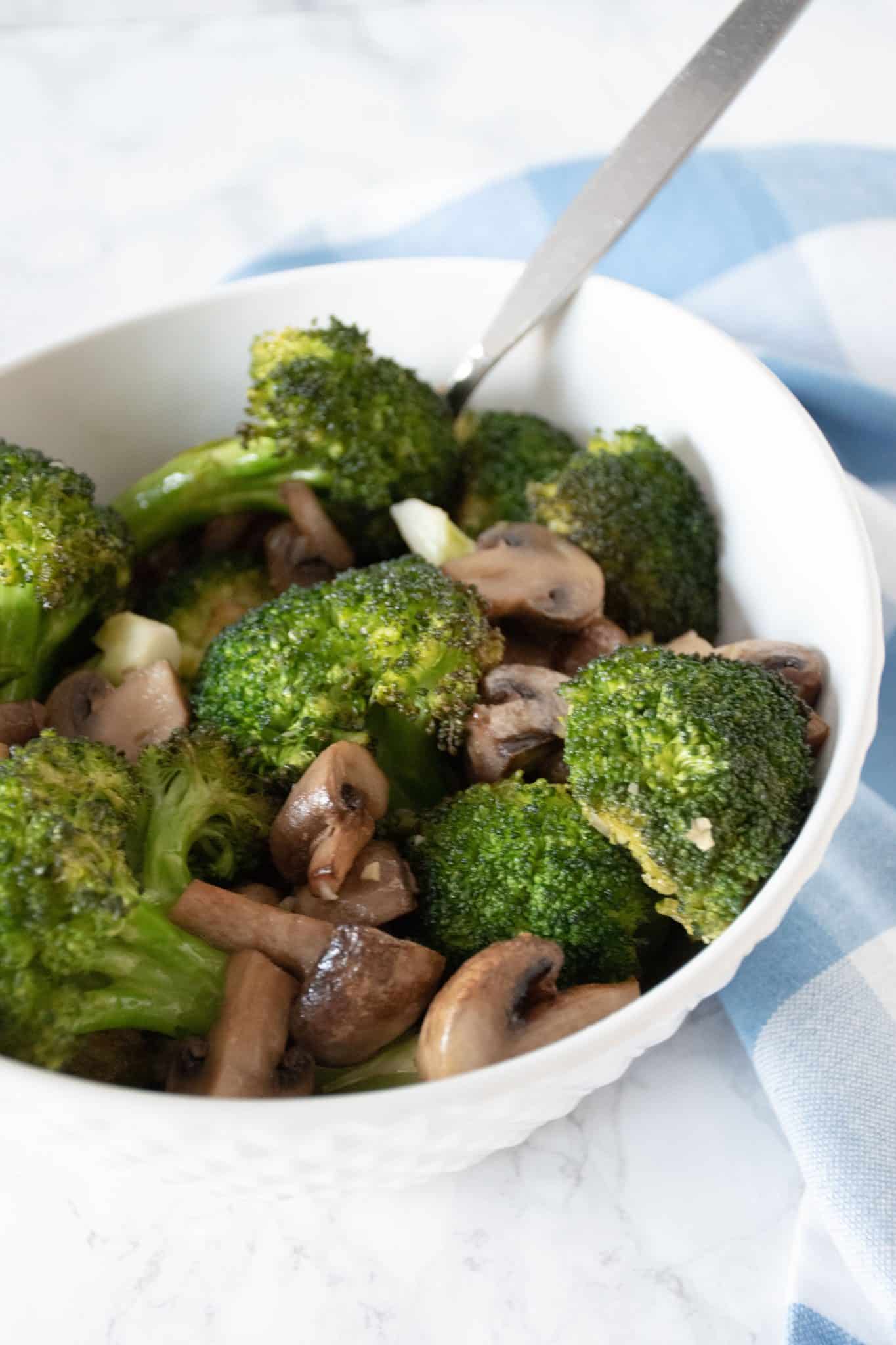 Roasted broccoli and mushrooms in a bowl.