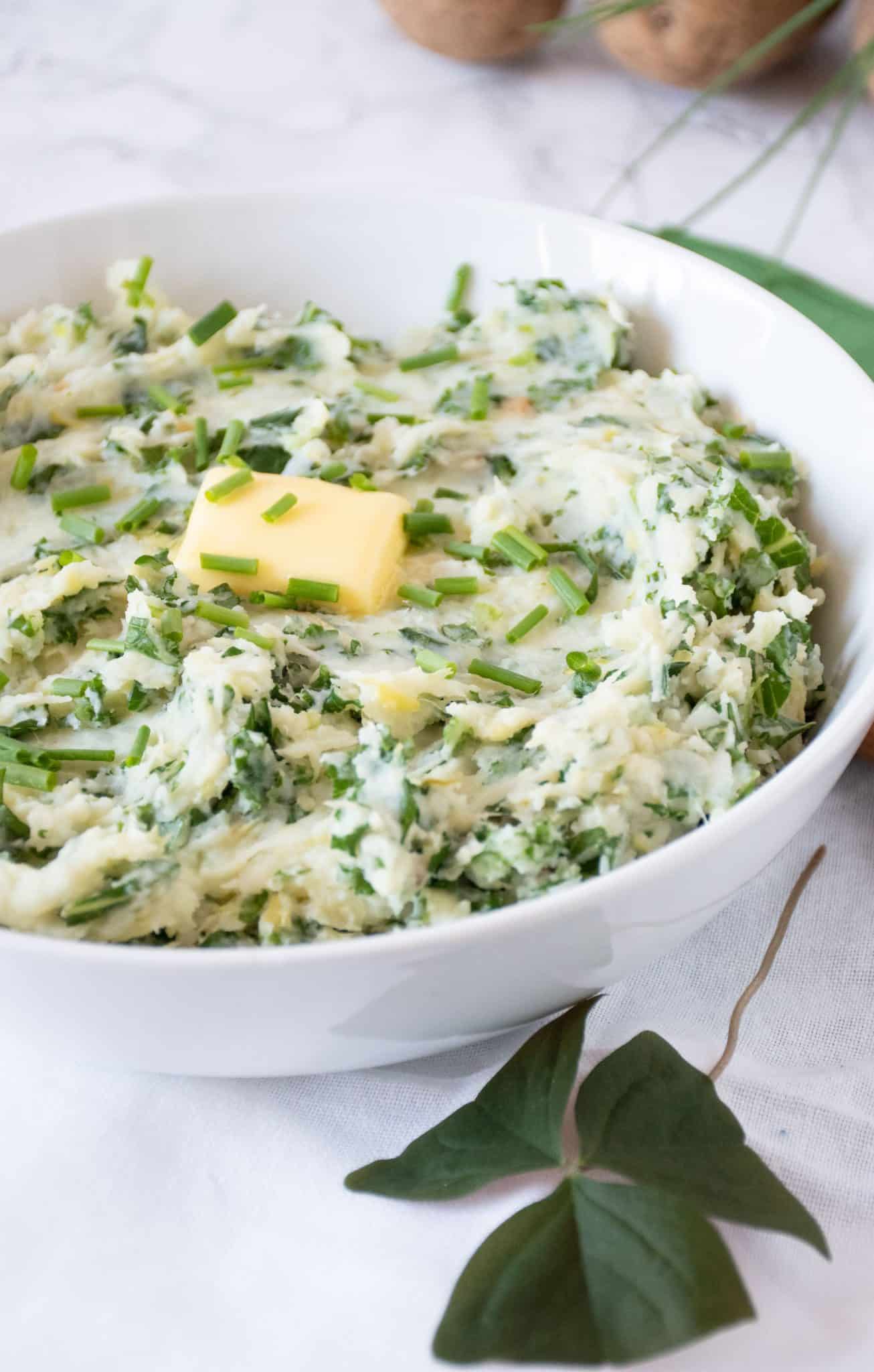 Bowl of Irish mashed potatoes with a pat of butter on top.