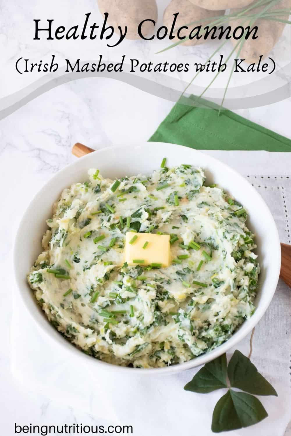 Bowl of mashed potatoes with a pat of butter on top. Text overlay: Healthy Colcannon (Irish mashed potatoes with kale).