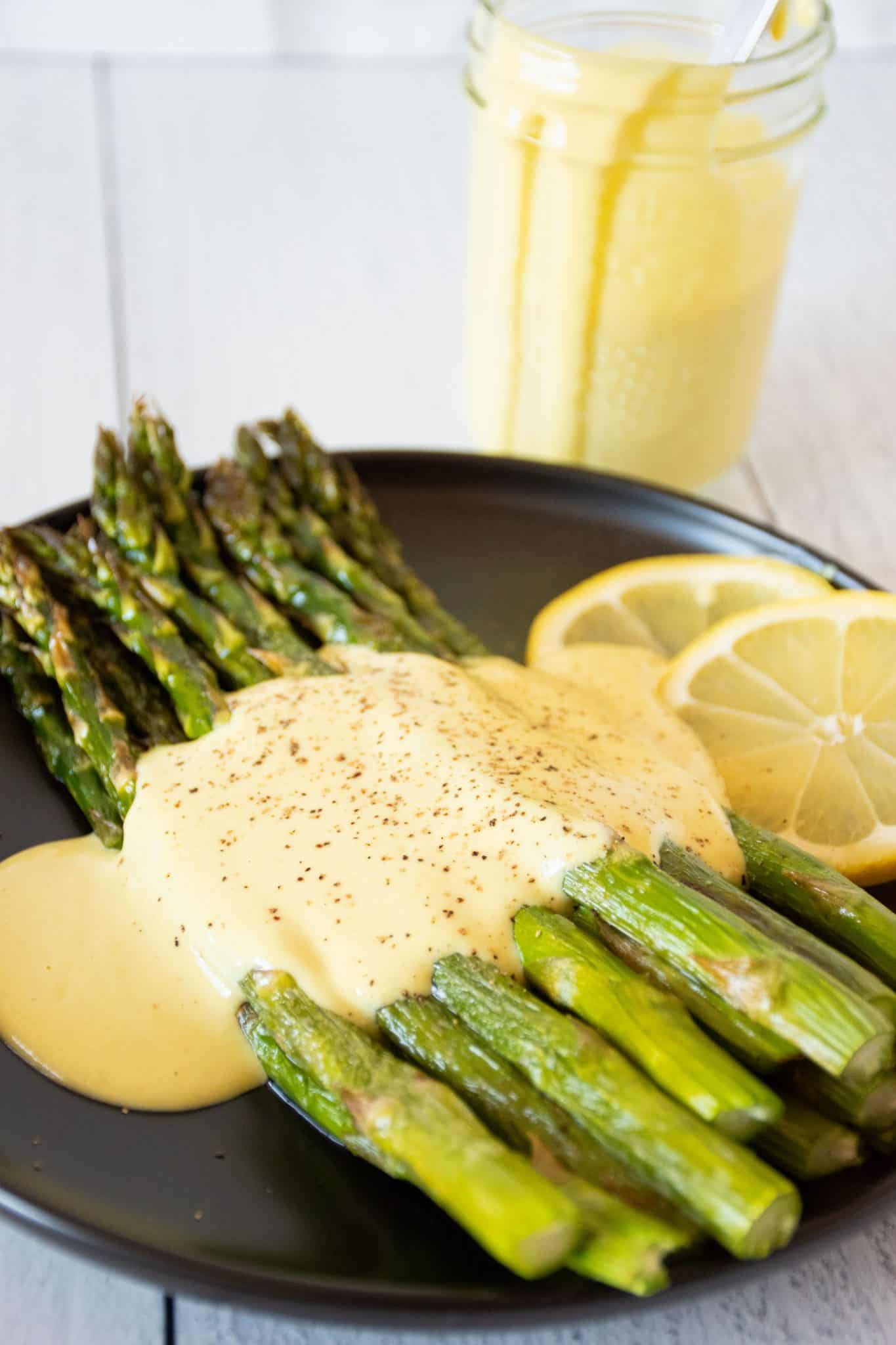 Asparagus spears drizzled with hollandaise sauce