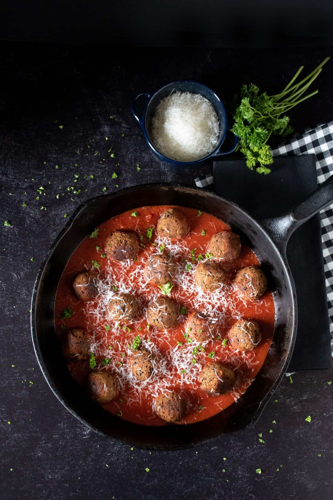 Overhead picture of skillet of black bean meatballs with marinara sauce.