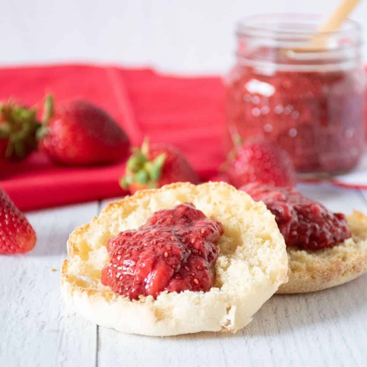 Toasted English Muffin with strawberry jam on it.