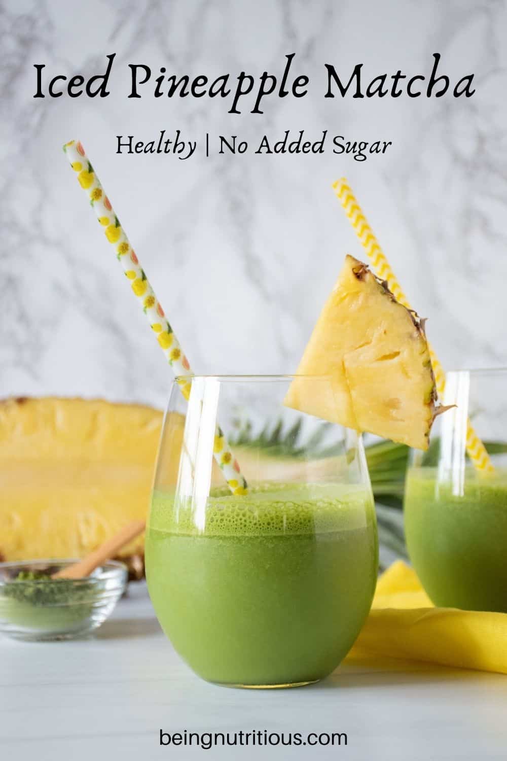 Glass of iced matcha drink, garnished with a pineapple slice. Text overlay: Iced Pineapple Matcha; healthy, no added sugar.
