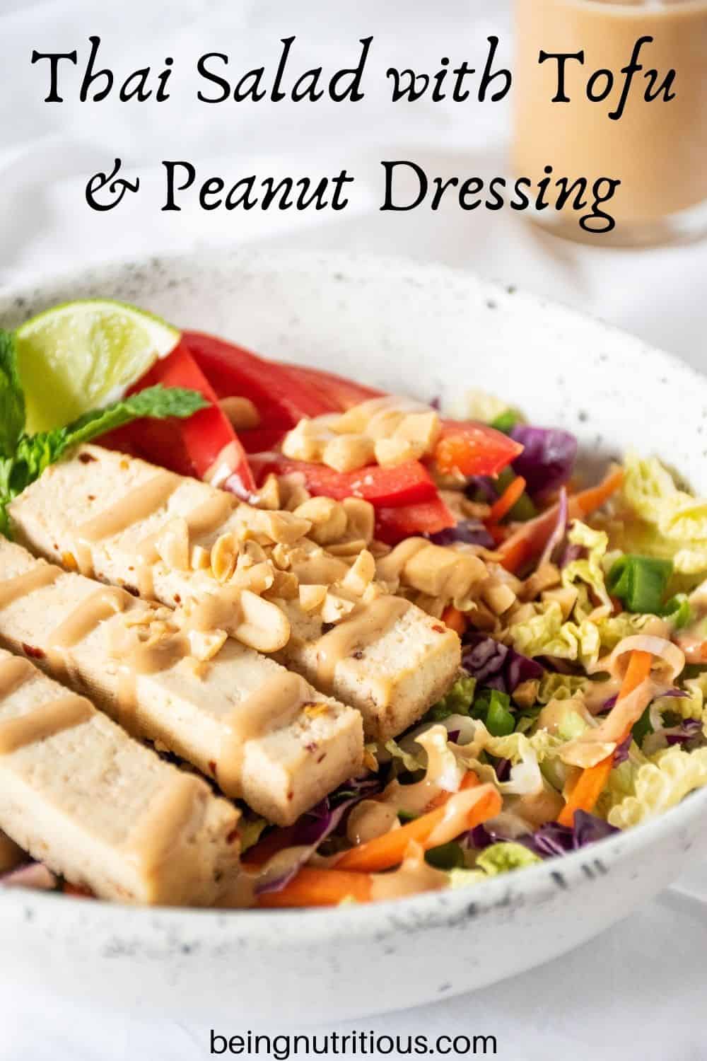 Bowl of Thai salad with tofu. Text overlay: Thai Salad with Tofu and Peanut Dressing.