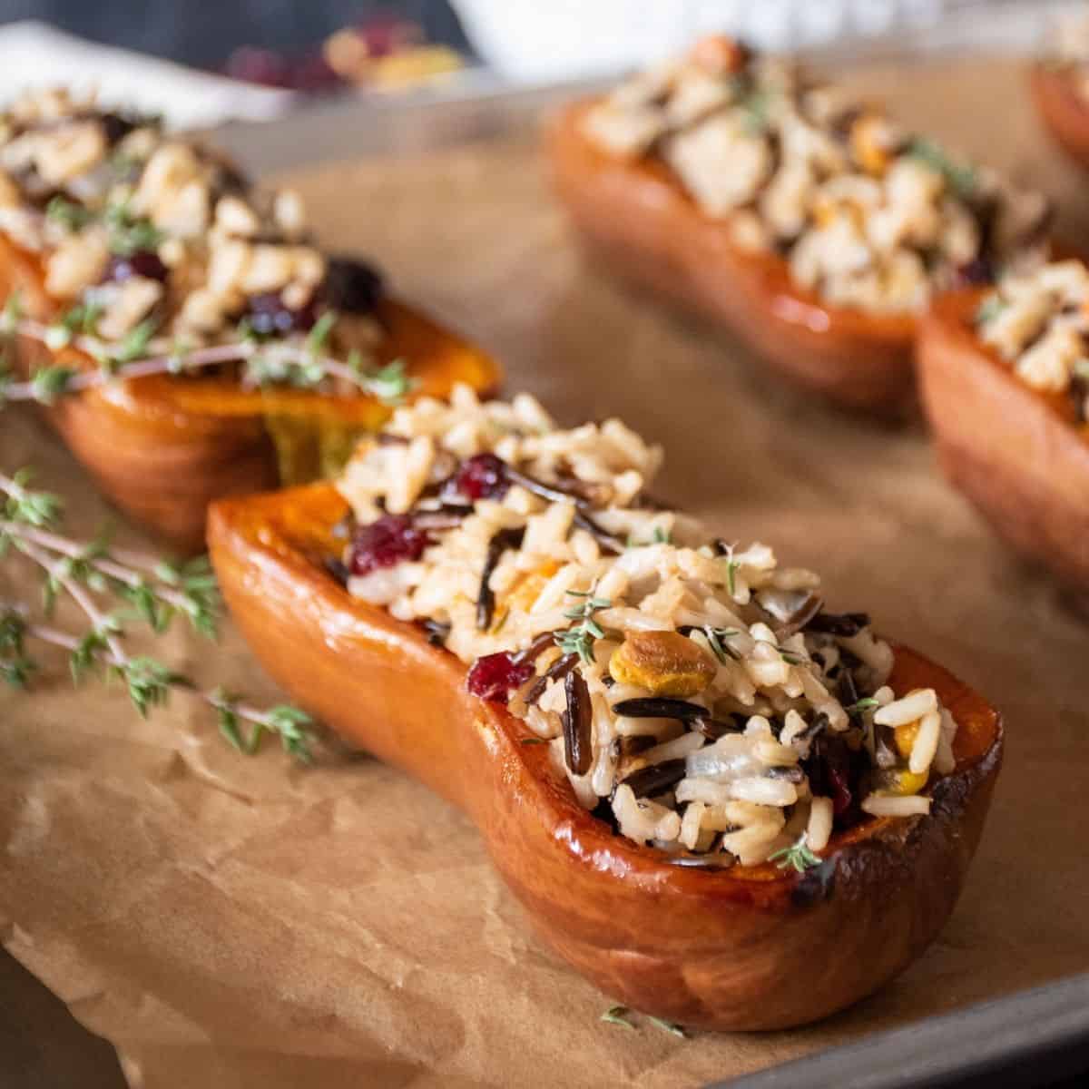 Honeynut Squash Stuffed with Cranberry Wild Rice Pilaf - Being Nutritious