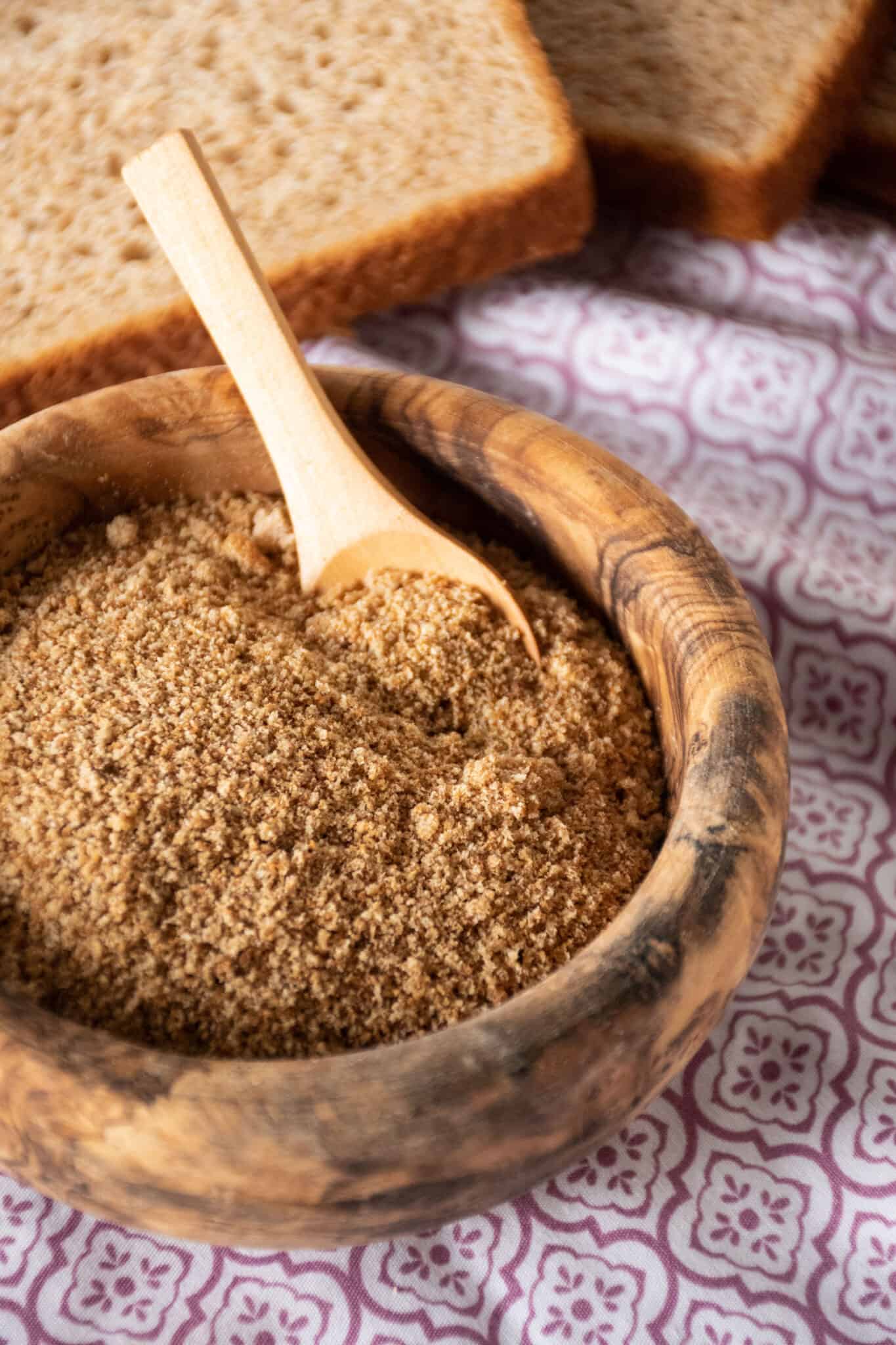 Small wooden bowl filled with homemade bread crumbs.