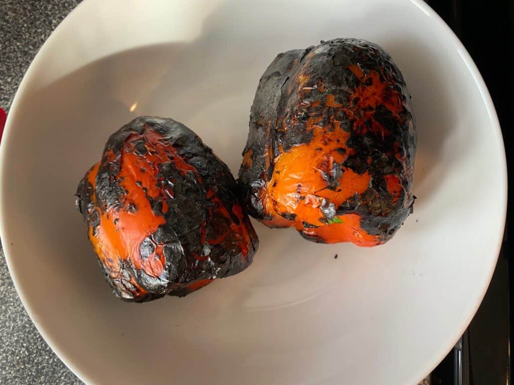 Charred red peppers in a bowl.