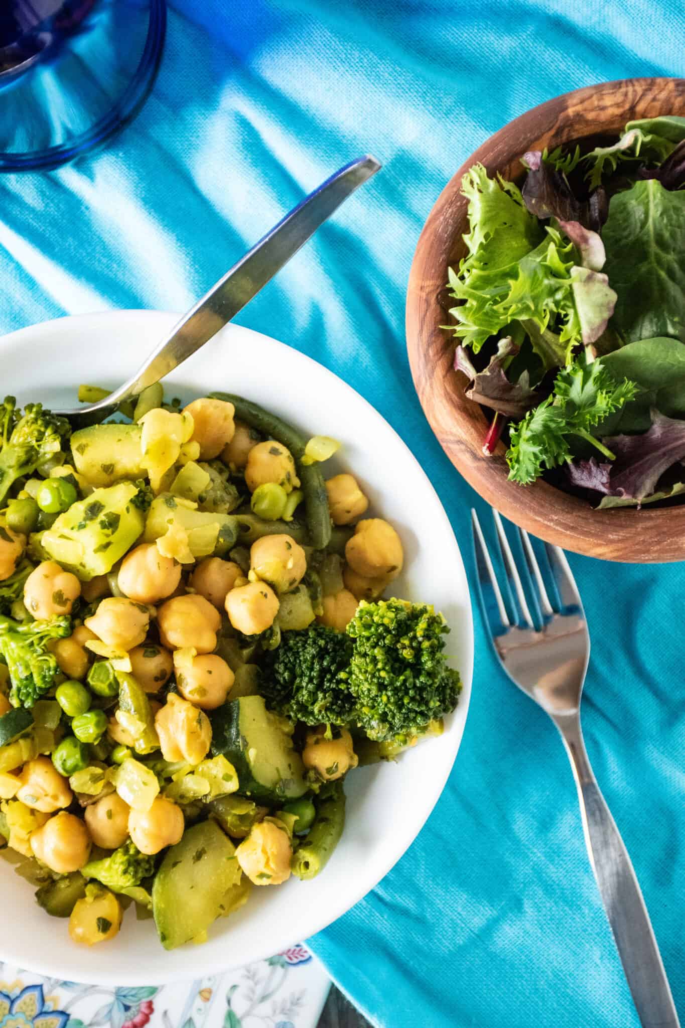 Overhead picture of vegetable hash in a bowl with a side salad.