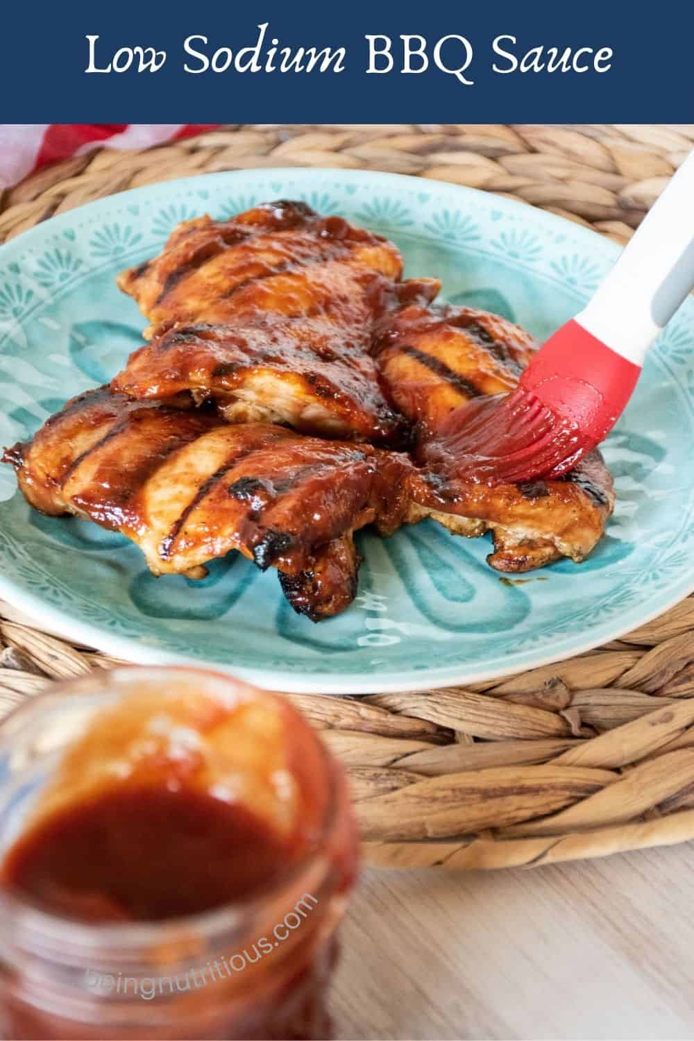 Plate of grilled chicken with BBQ sauce being brushed on. Text overlay: Low Sodium BBQ Sauce