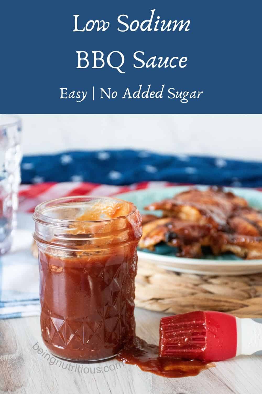 BBQ sauce in a mason jar with grilled chicken on a plate in the background. Text overlay: Low Sodium BBQ Sauce; easy, no added sugar.