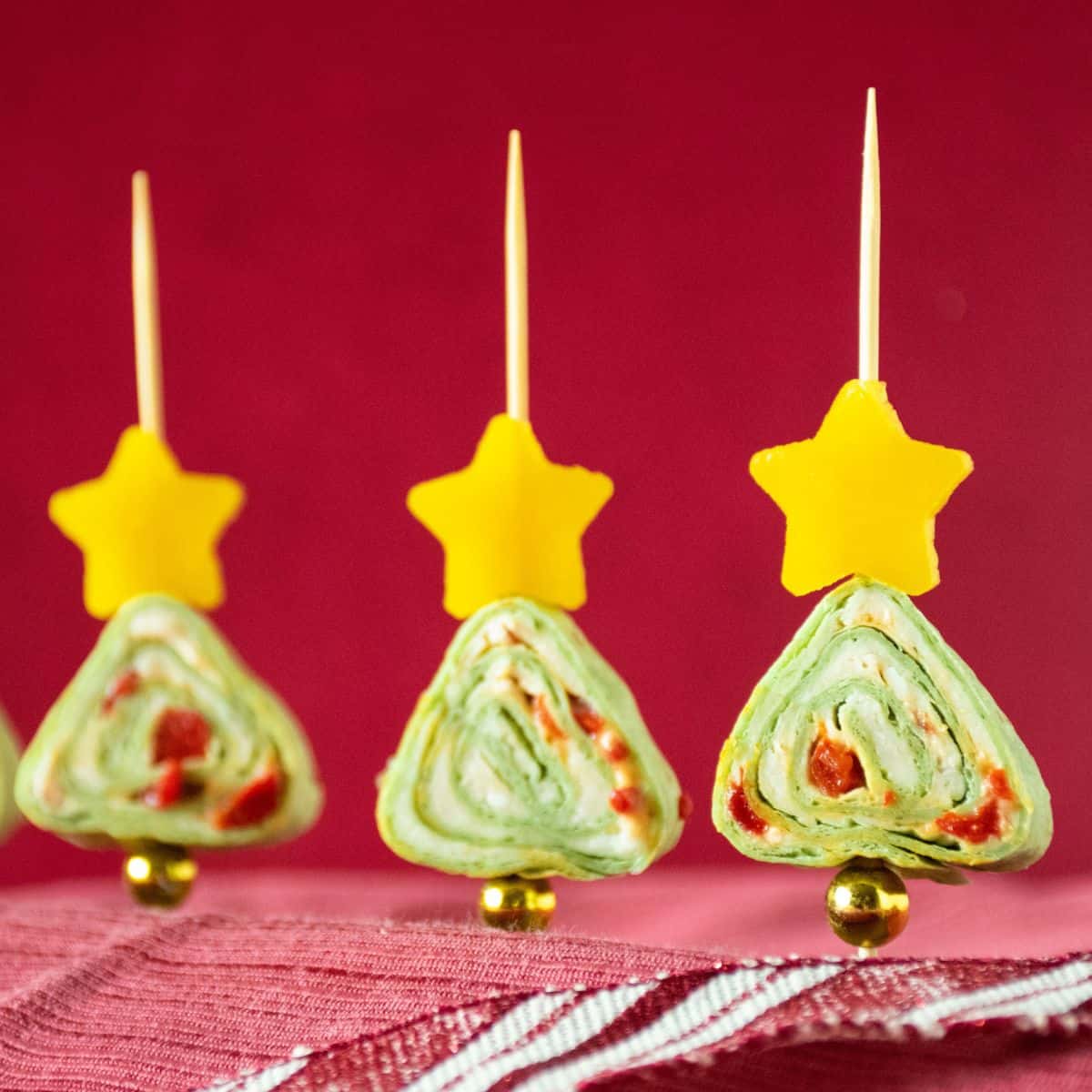 Green tortilla roll up appetizers shaped like a Christmas tree.