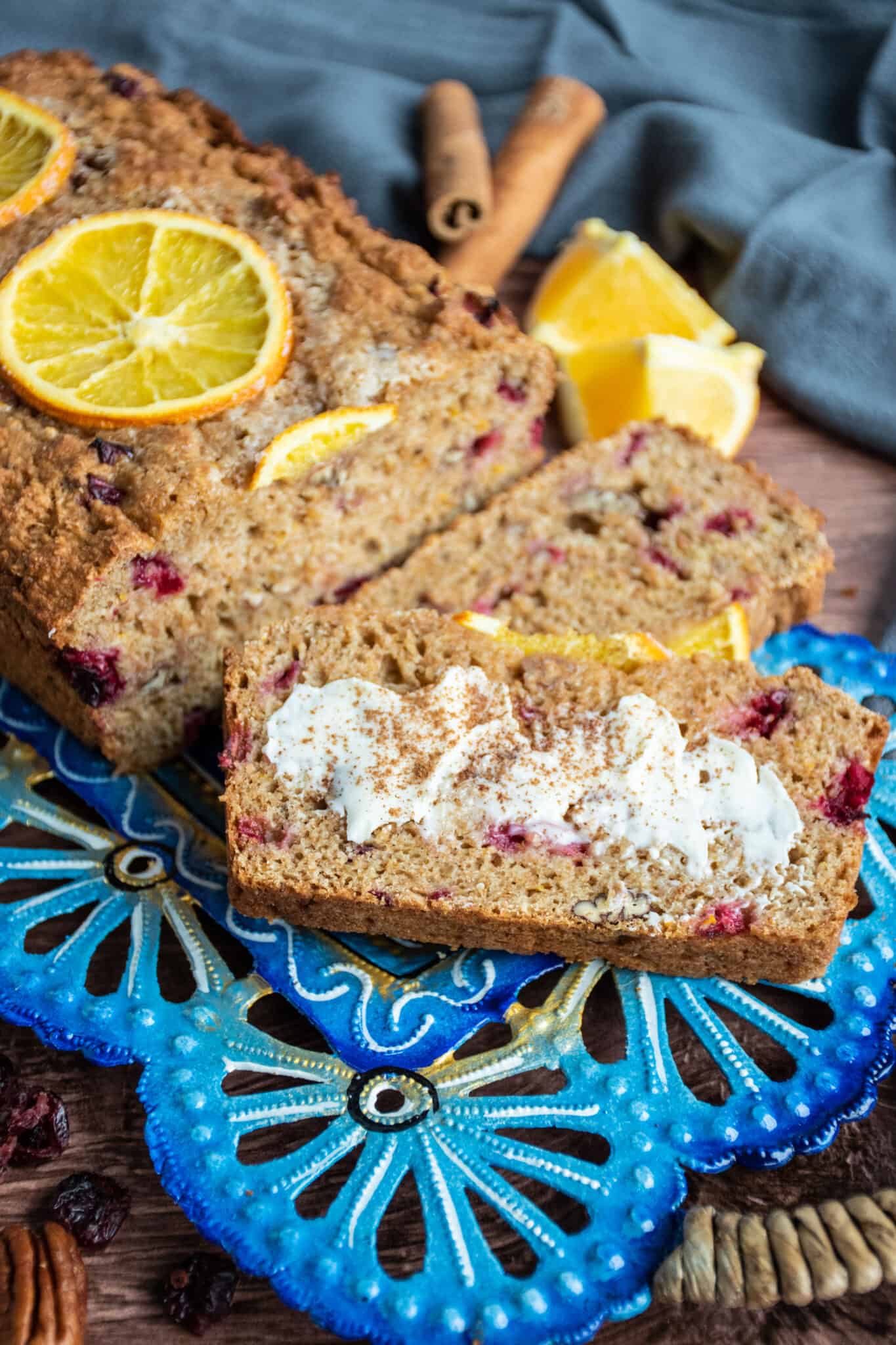 Tray of sliced quick bread, one with butter and cinnamon sprinkled on.