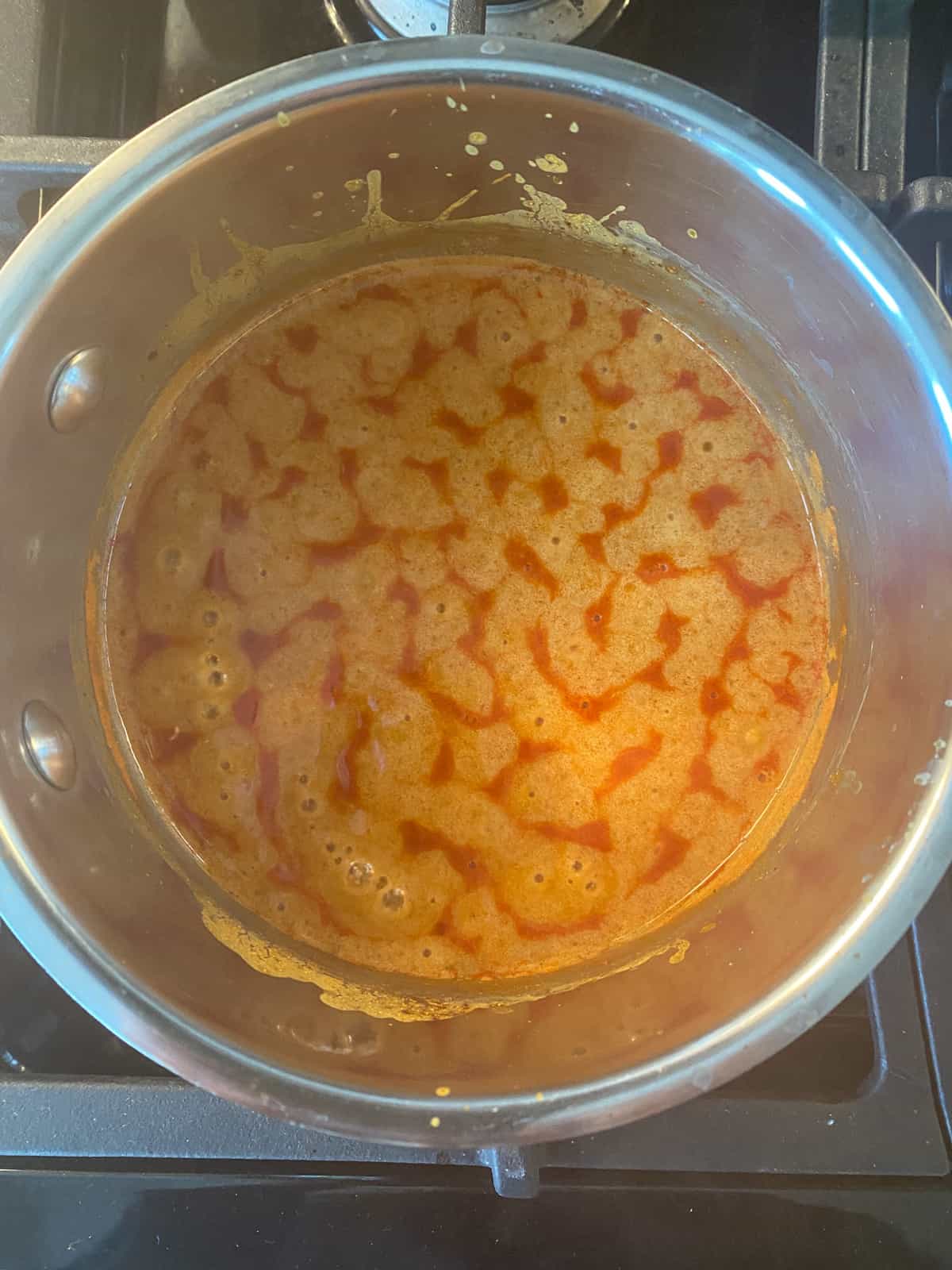 Sauce ingredients simmering in a sauce pan.