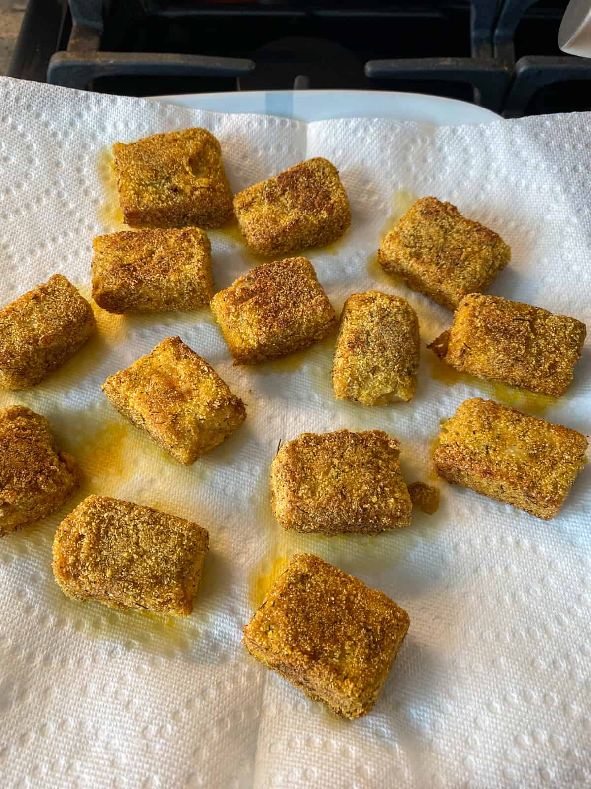 Finished tempeh draining on a paper towel.