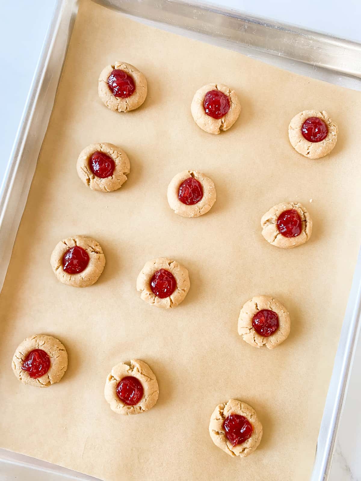 Unbaked cookies filled with jam.
