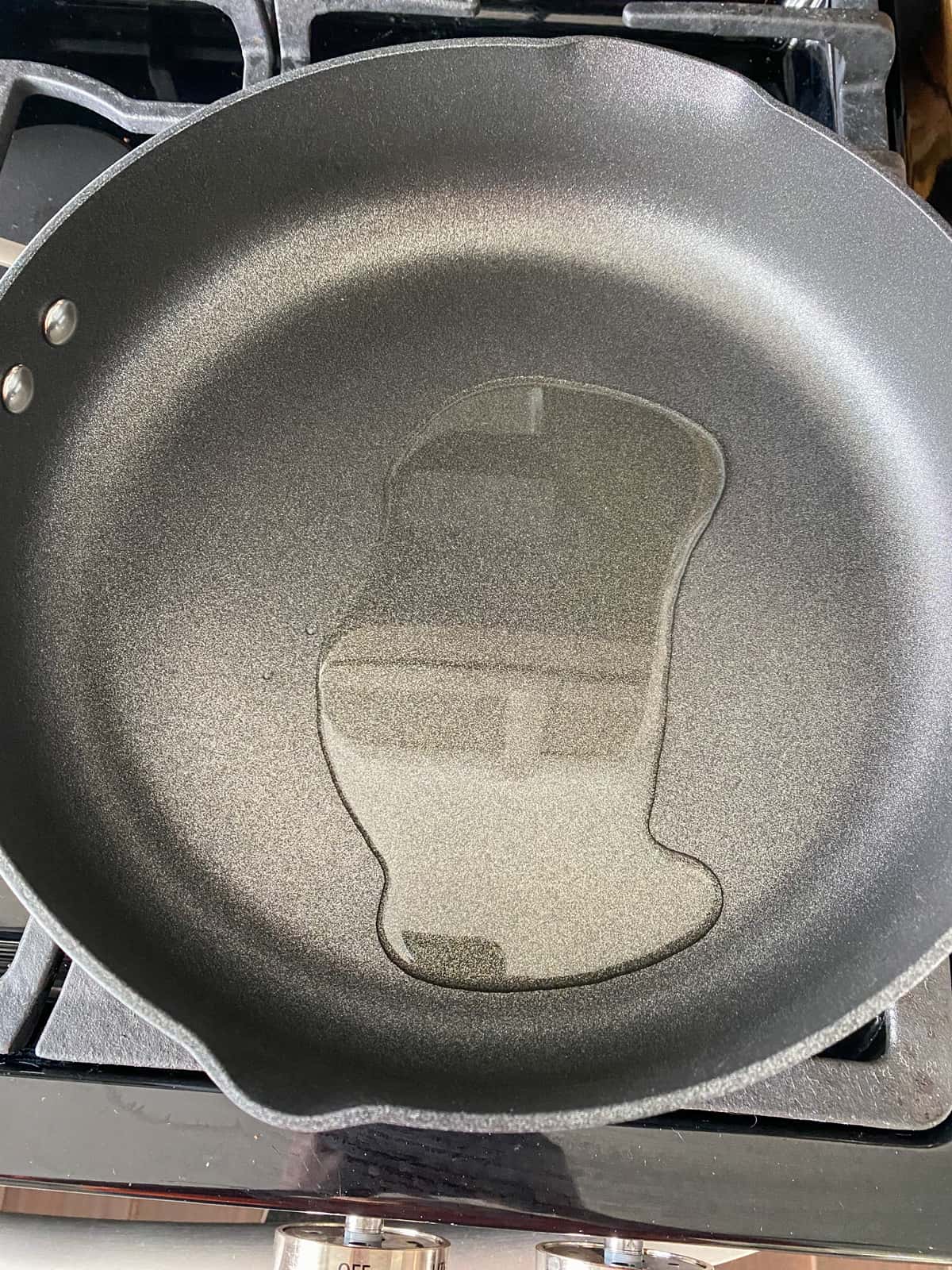 Oil heating in a skillet.