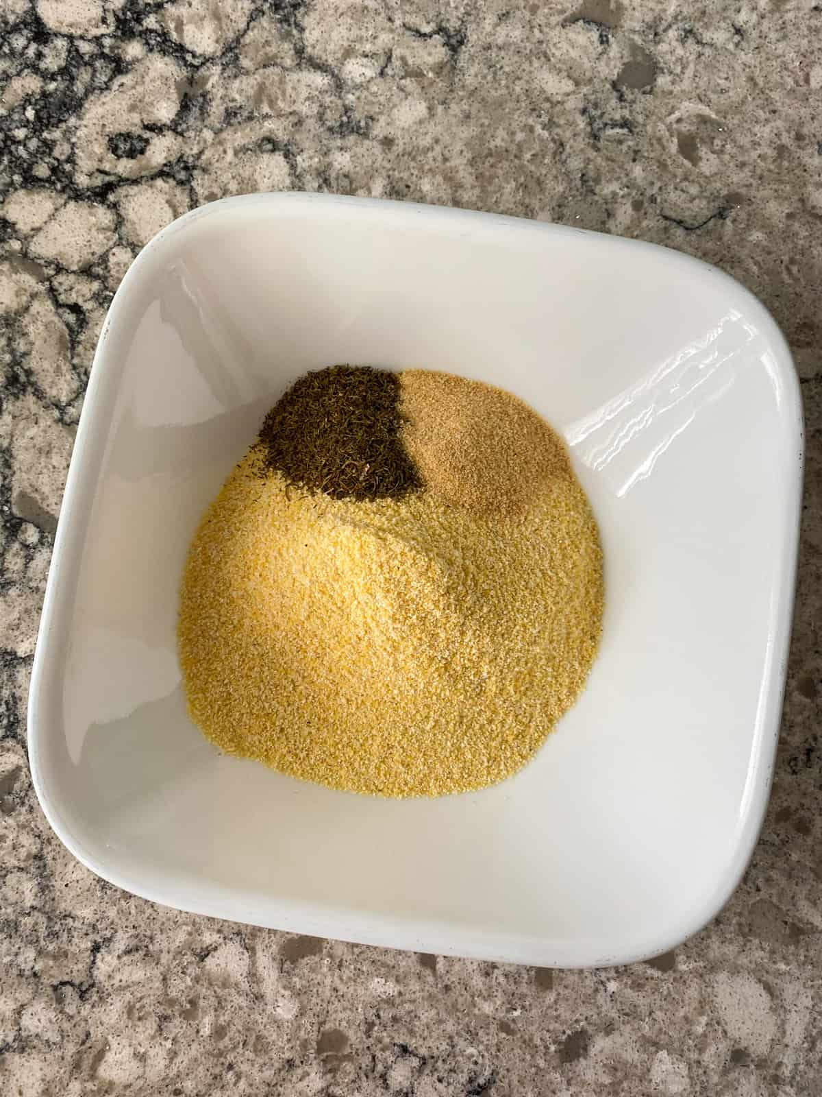 Cornmeal breading ingredients in a bowl.