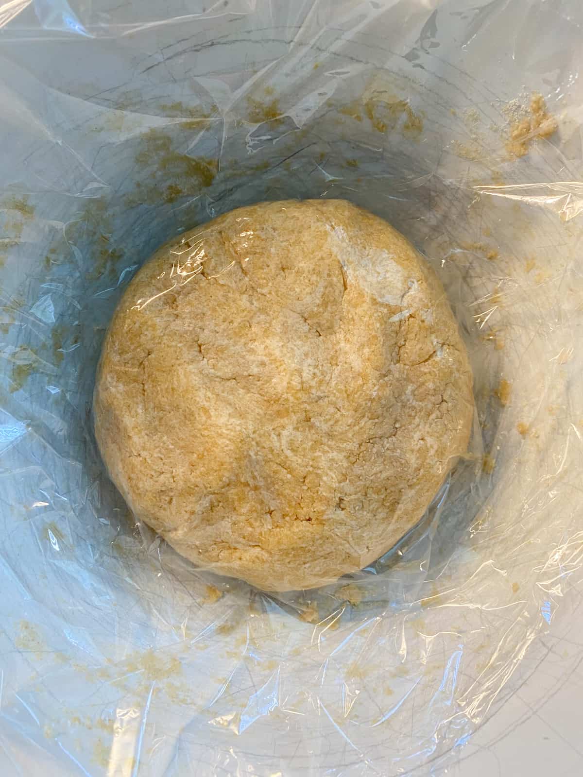 Mixed dough, formed into a disk, covered with plastic wrap.