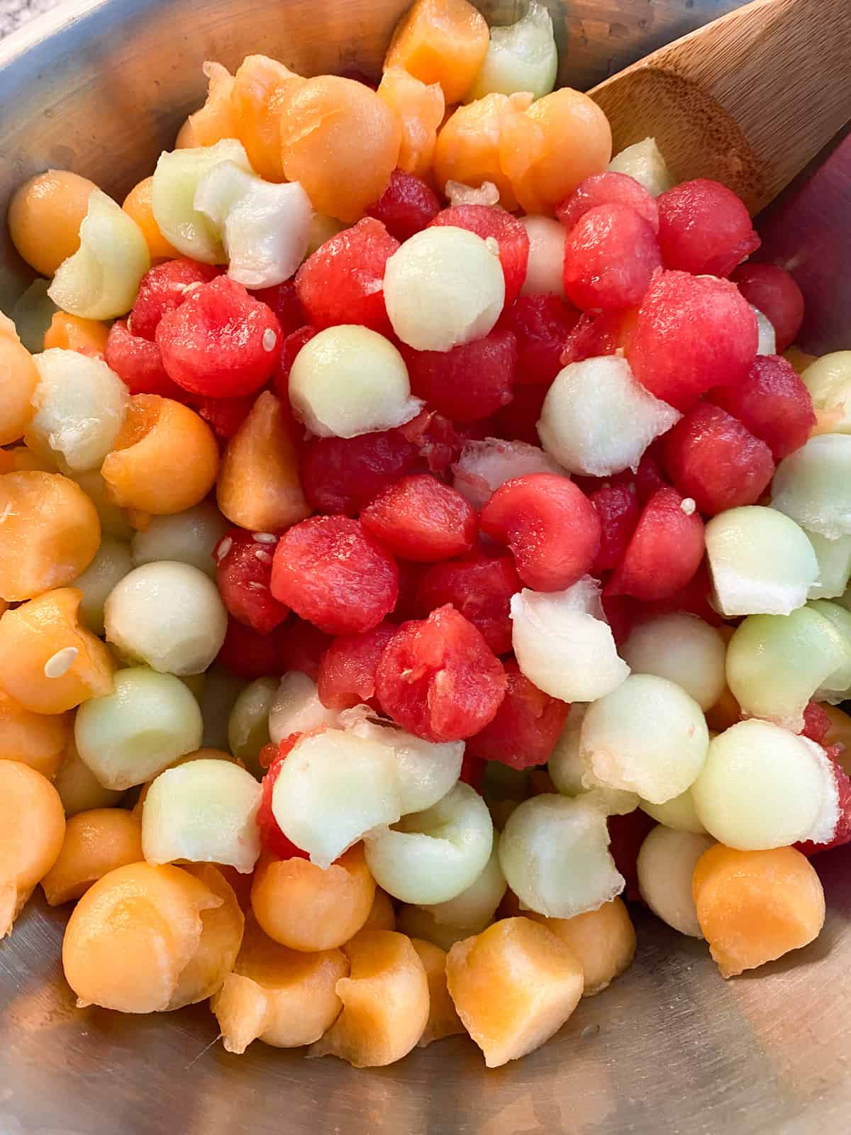 Mixed melon balls in a bowl.