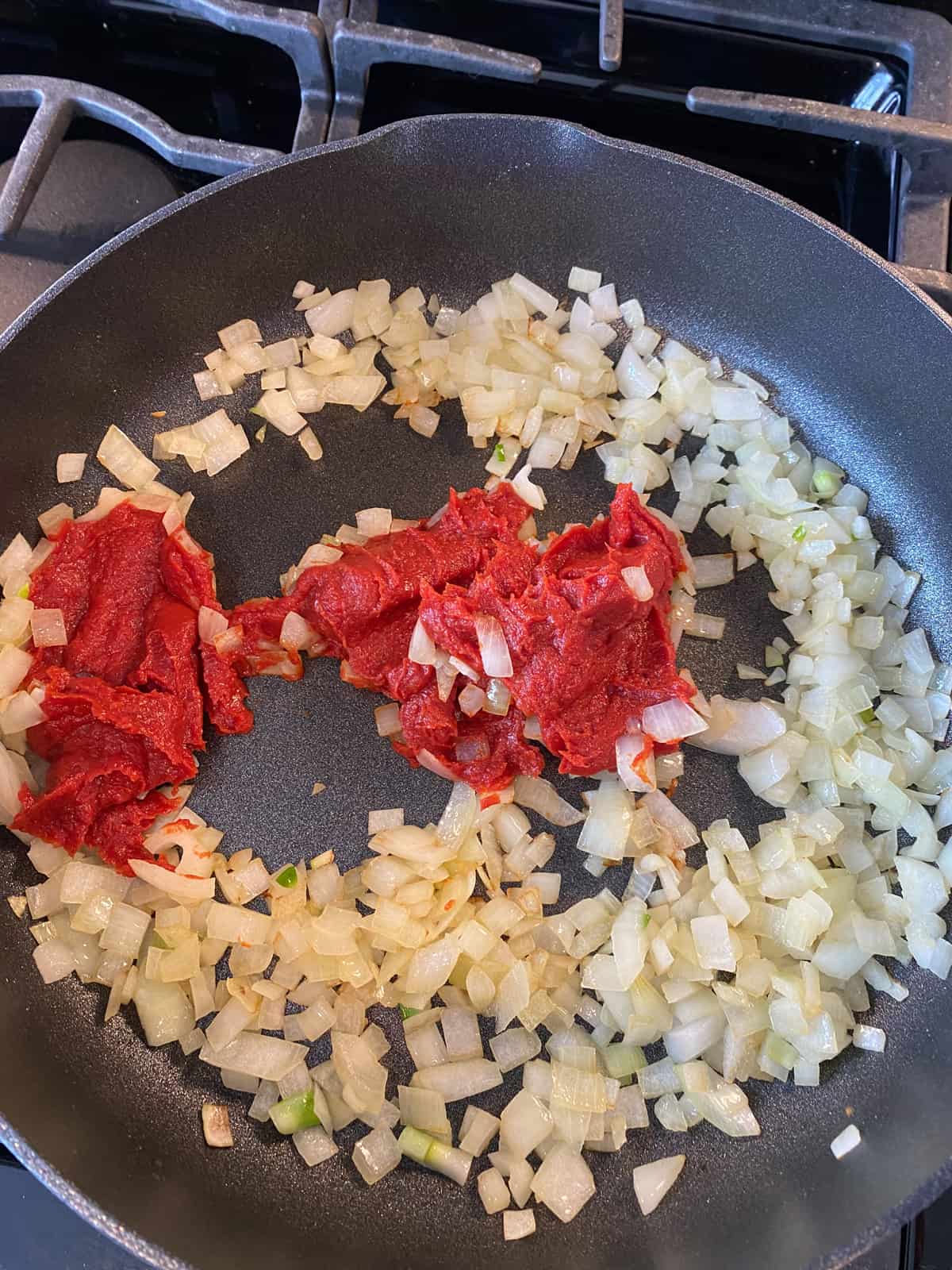 Tomato paste added to sauteed onions