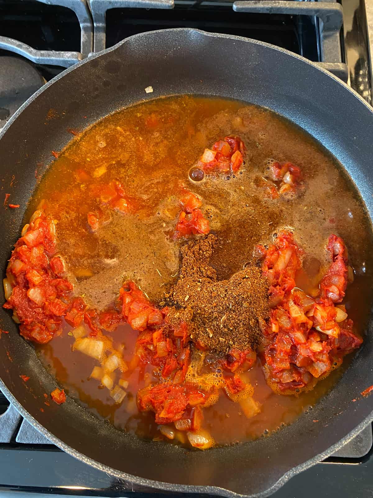 Water and spices added to skillet