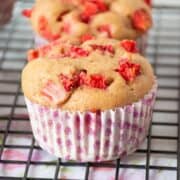 Close up of a strawberry muffin on a wire rack.