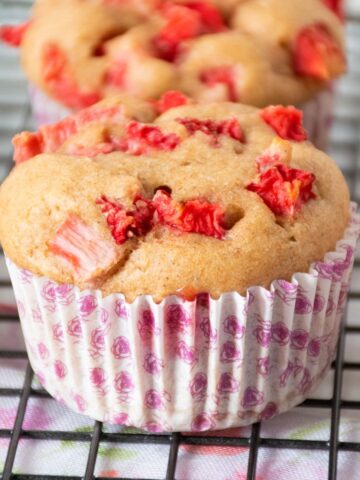 Close up of a strawberry muffin on a wire rack.