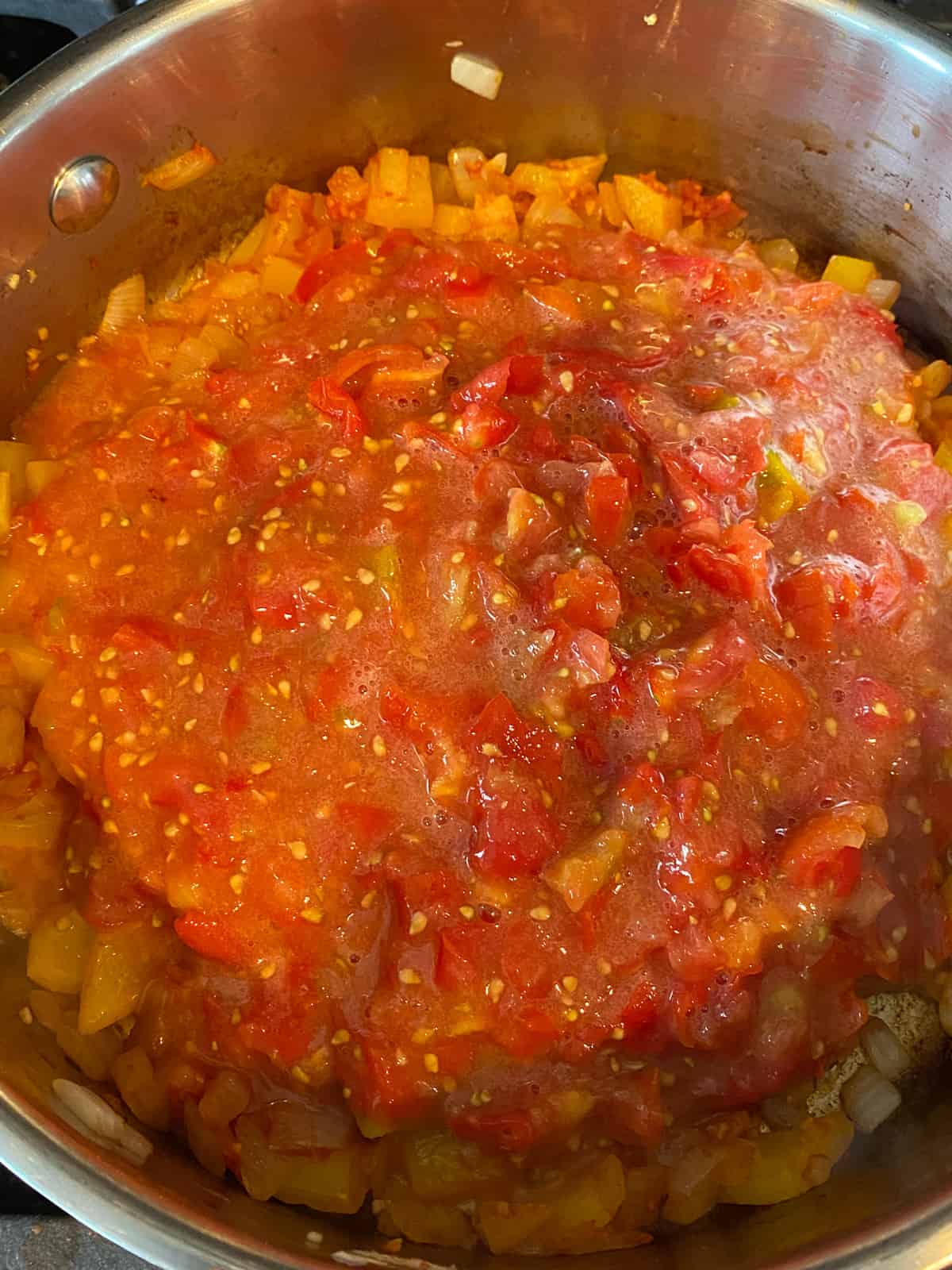 Added the diced tomatoes to the pan.