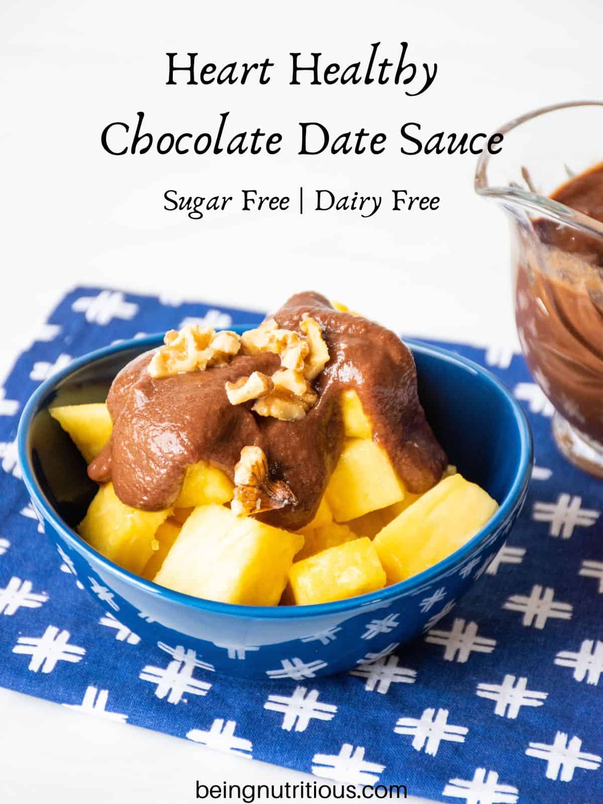 Bowl of pineapple covered with chocolate sauce and chopped walnuts. Text overlay: Heart Healthy Chocolate Date Sauce; sugar free, dairy free.