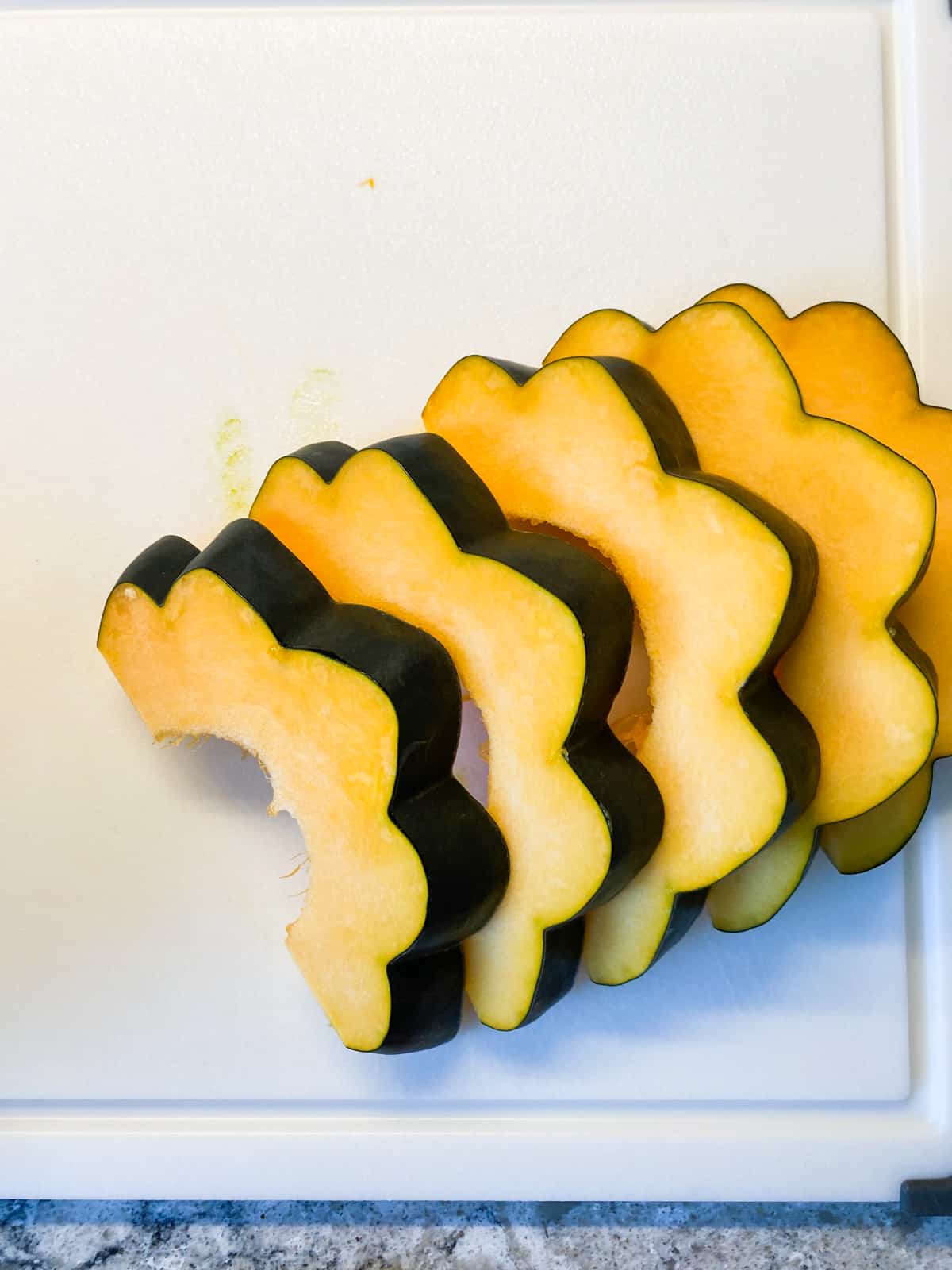 Half of an acorn squash, cut into slices.