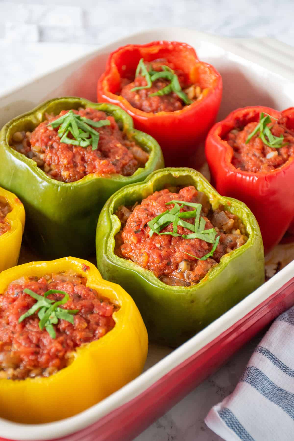 A pan of 6 baked stuffed bell peppers.