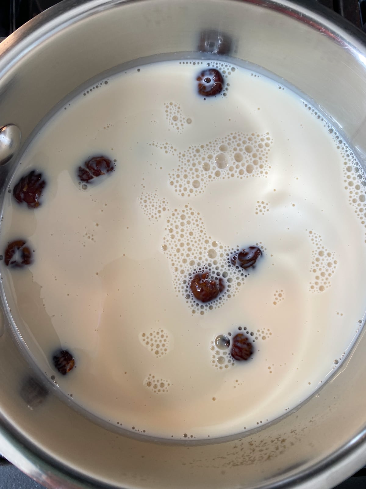 Milk and dates in a saucepan.