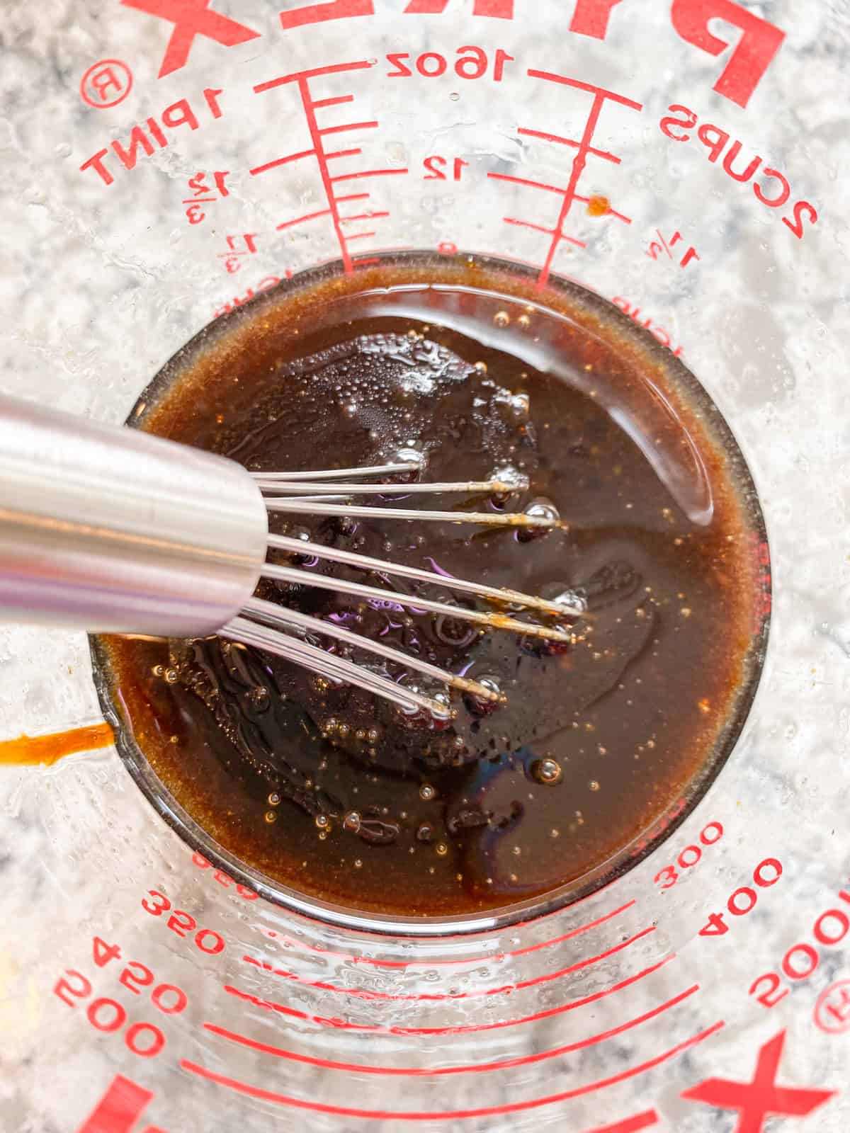 All the wet ingredients mixed together in a glass liquid measuring cup.