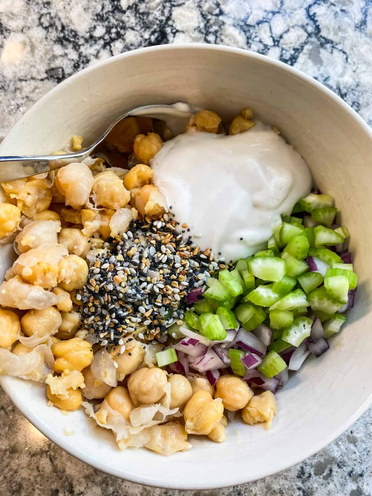 All ingredients for the chickpea salad, in a bowl, ready to mix.