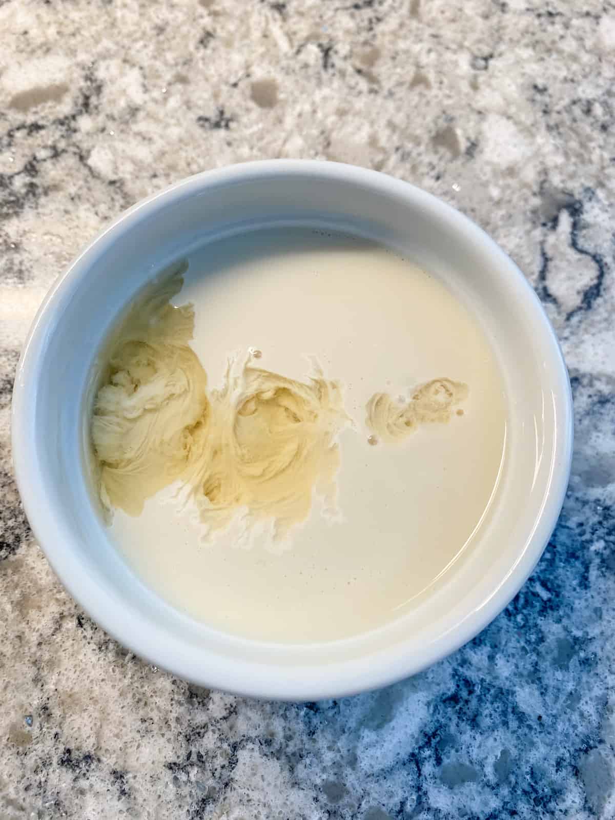 Small bowl with soy milk and vinegar.