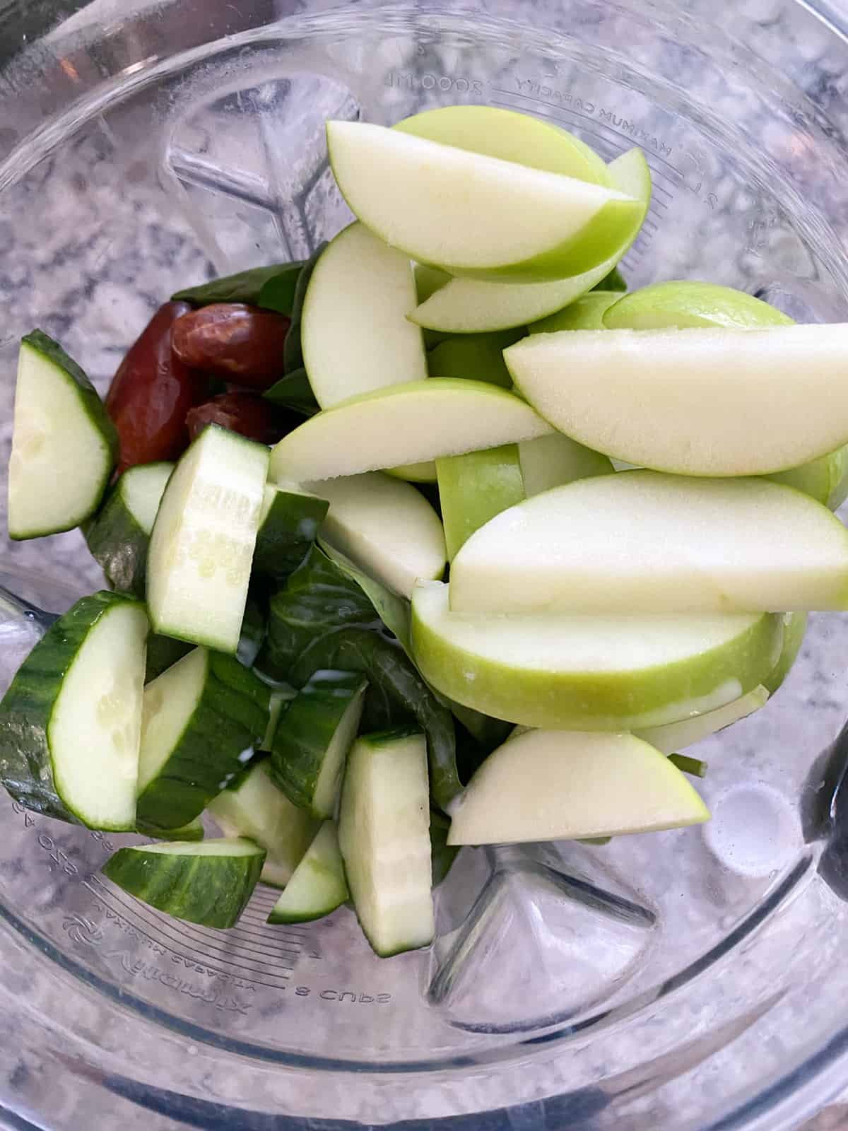 Chopped apple cucumber smoothie ingredients in a blender.