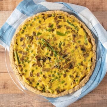Overhead image of whole eggless quiche in a pie plate.