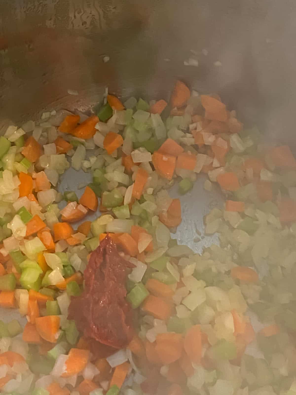 Tomato paste added to the sauteing vegetables.