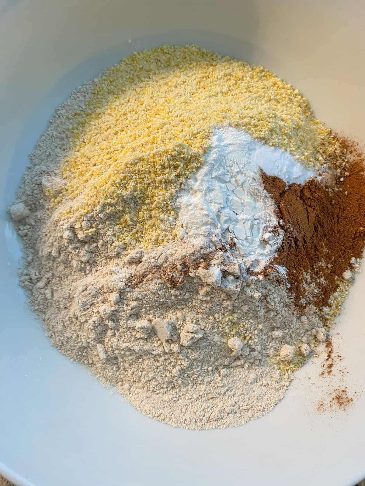 Dry ingredients for cornbread in a bowl.