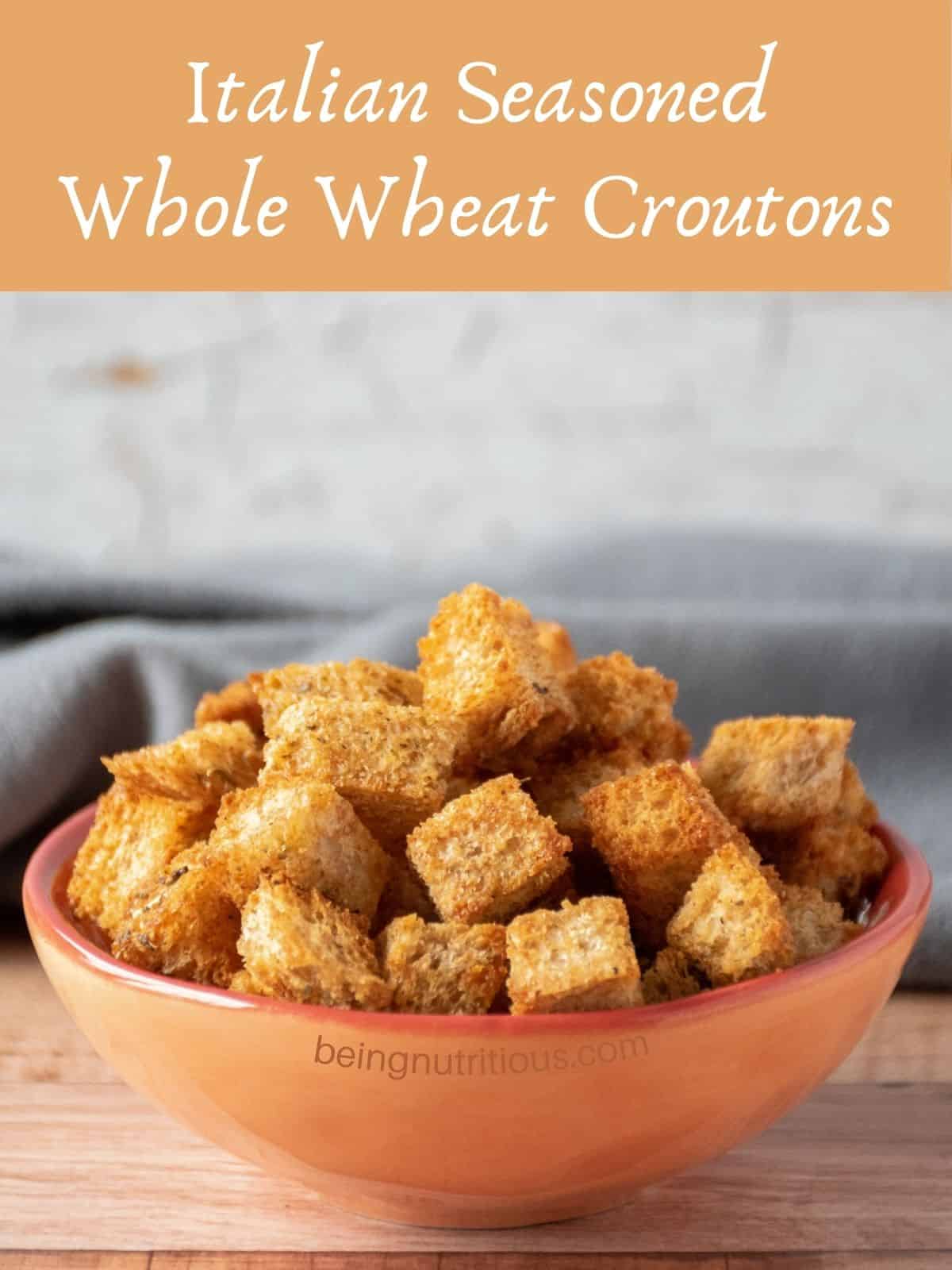 Croutons in a small bowl. Text overlay: Italian Seasoned Whole Wheat Croutons.