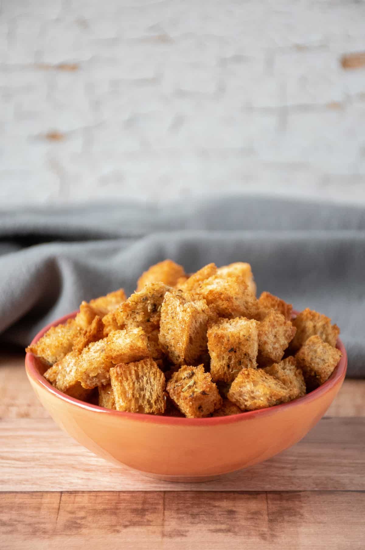 Whole wheat croutons in a small bowl.
