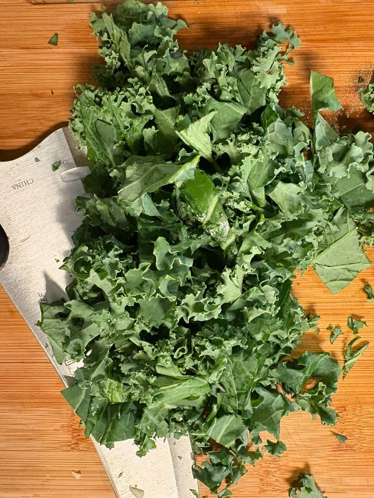 Chopped kale on a cutting board.