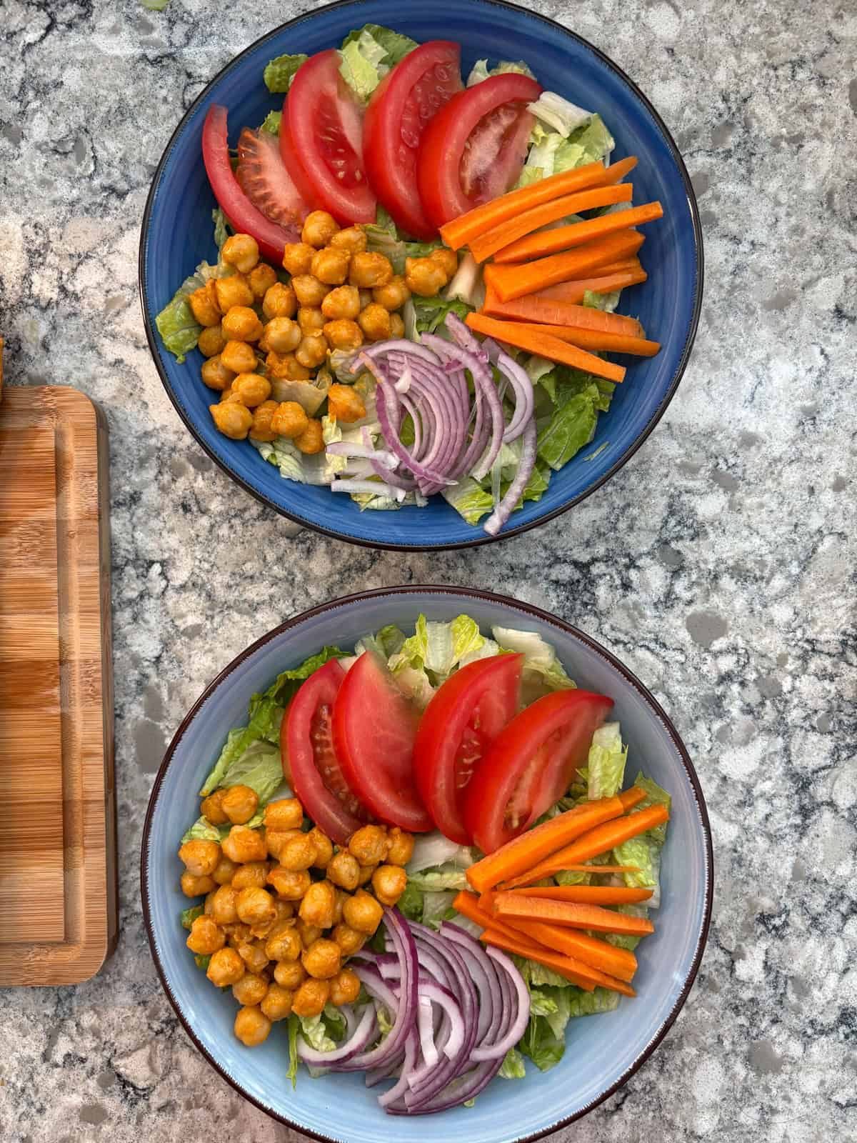 Buffalo chickpeas added to the salad bowls.
